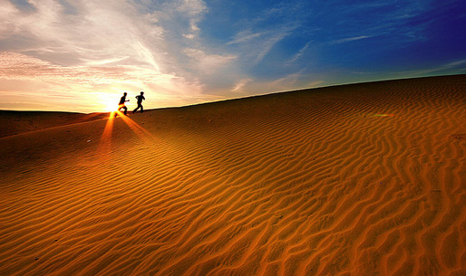 White sand dunes on sunrise, Mui Ne, Vietnam. With lens flare and light leak